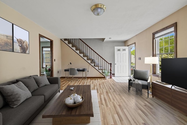 32 Dale St, Franklin, MA 02038 - living room featuring stairway, light wood-style flooring, and a baseboard heating unit