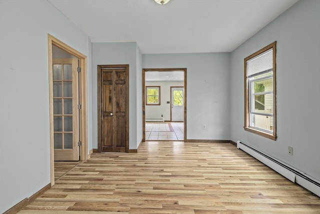 32 Dale St, Franklin, MA 02038 - spare room featuring baseboard heating, light wood-style flooring, and a baseboard heating unit
