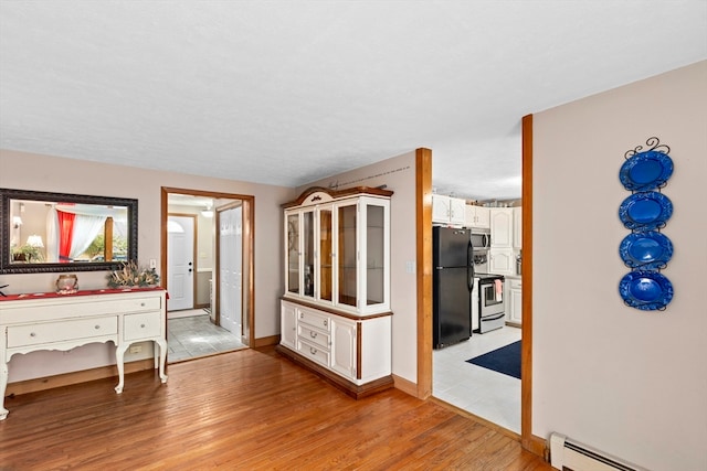 interior space featuring light hardwood / wood-style floors and a baseboard heating unit