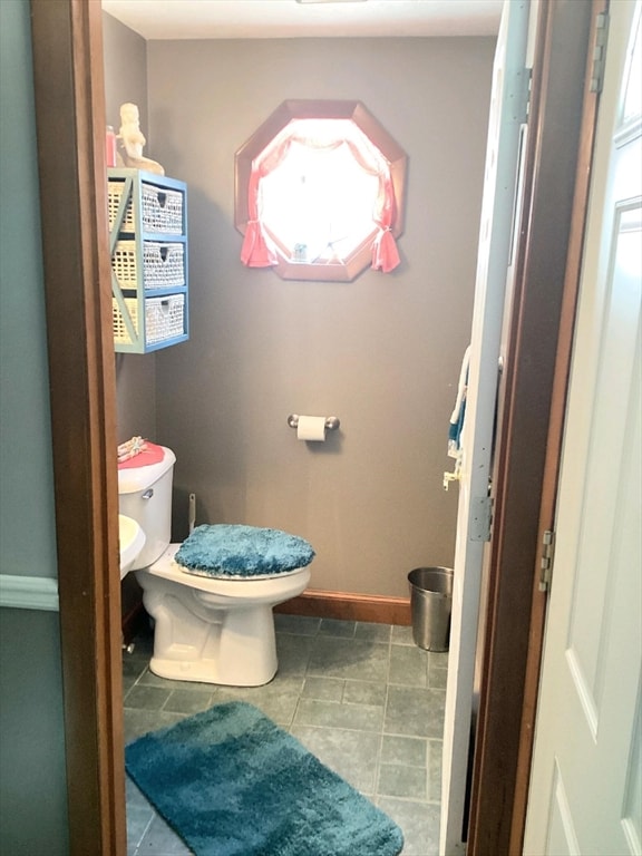 bathroom with tile patterned flooring and toilet