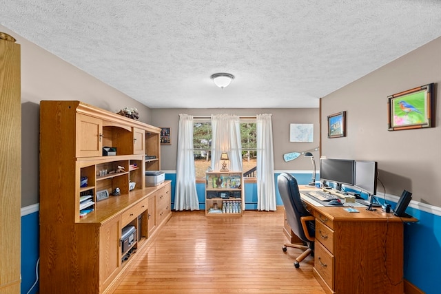 office area featuring a textured ceiling and light hardwood / wood-style floors