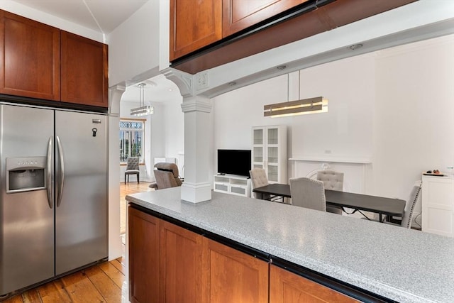 6 Brigham St Unit 1, Boston, MA 02128 - kitchen with stainless steel fridge with ice dispenser, decorative columns, light wood-style floors, open floor plan, and brown cabinets