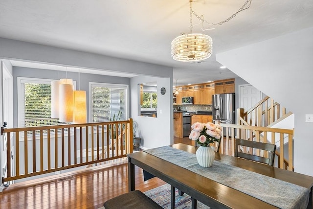 dining space with wood finished floors