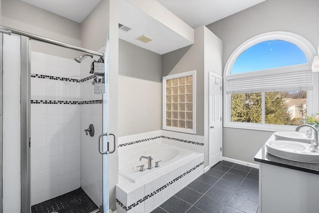 bathroom featuring tile patterned floors, visible vents, a garden tub, a stall shower, and a sink