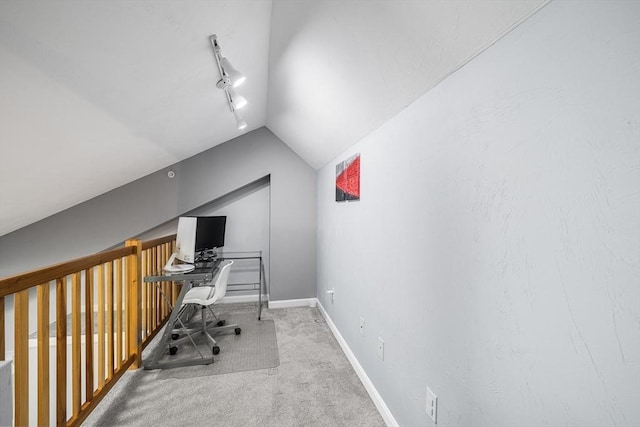 office space featuring lofted ceiling, baseboards, carpet floors, and track lighting