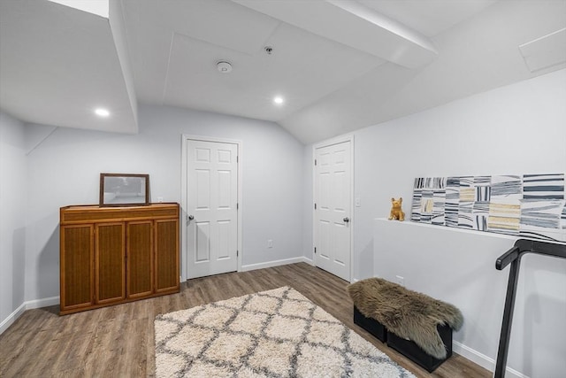 living area featuring recessed lighting, baseboards, and wood finished floors