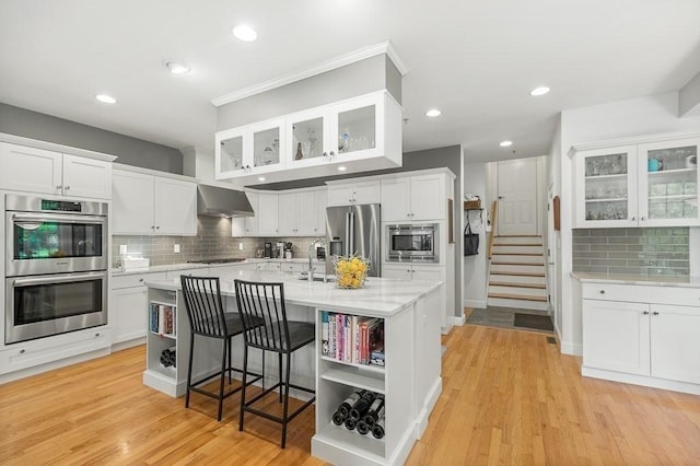 14 Parsons Hill Rd, Wenham, MA 01984 - kitchen with stainless steel appliances, wall chimney exhaust hood, decorative backsplash, white cabinetry, and recessed lighting