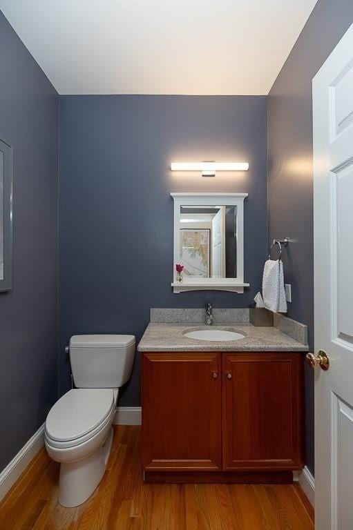 14 Parsons Hill Rd, Wenham, MA 01984 - bathroom featuring wood finished floors, vanity, toilet, and baseboards