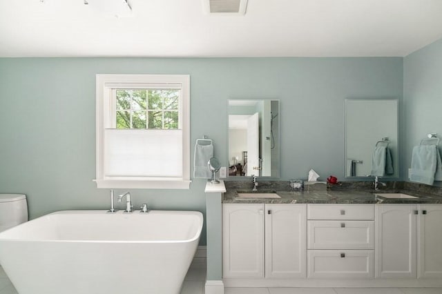 14 Parsons Hill Rd, Wenham, MA 01984 - full bathroom with a freestanding tub, double vanity, tile patterned floors, and toilet