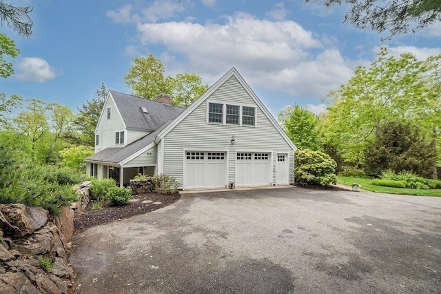 14 Parsons Hill Rd, Wenham, MA 01984 - view of side of home with driveway, a chimney, a shingled roof, and an attached garage