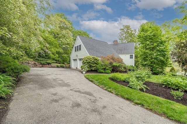 14 Parsons Hill Rd, Wenham, MA 01984 - view of home's exterior featuring a chimney, an attached garage, and driveway