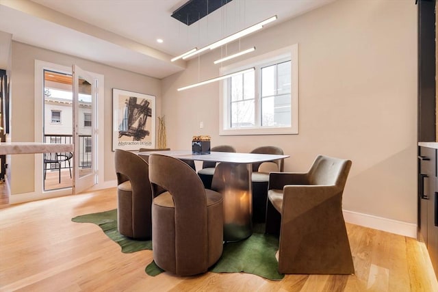 dining space featuring light wood-type flooring