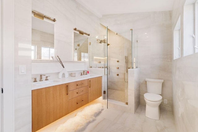 bathroom featuring vanity, toilet, walk in shower, and tile walls