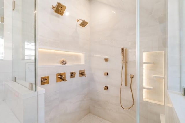 bathroom featuring a shower with shower door