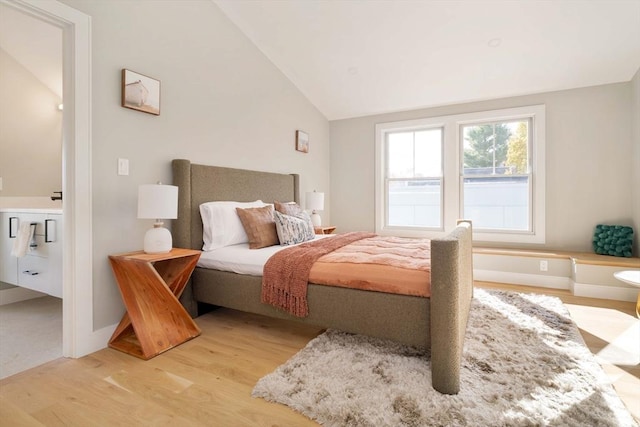 bedroom featuring light hardwood / wood-style floors and lofted ceiling