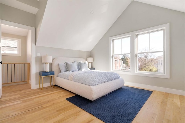 bedroom with lofted ceiling and hardwood / wood-style flooring