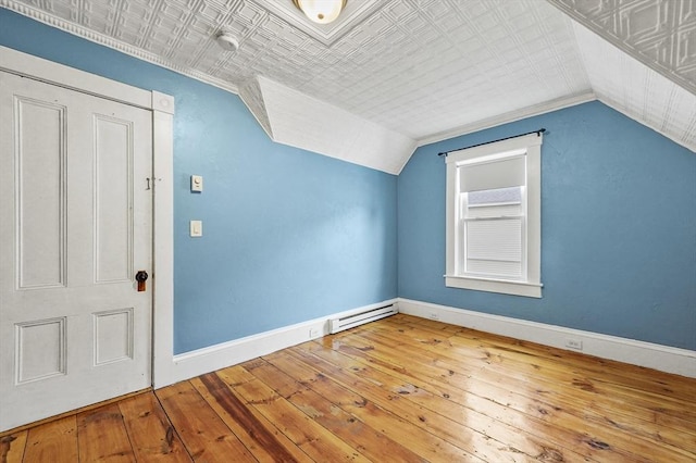 23 Starbird St, Lowell, MA 01854 - additional living space with lofted ceiling, hardwood / wood-style floors, and a baseboard radiator