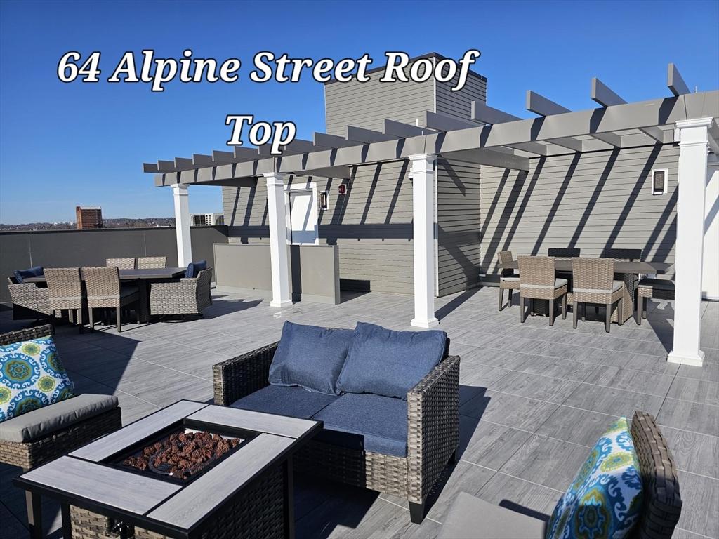 view of patio with a pergola and an outdoor living space with a fire pit