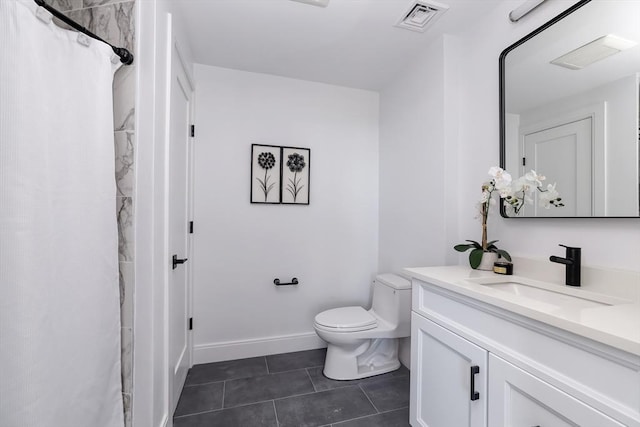 bathroom featuring tile patterned floors, toilet, and vanity