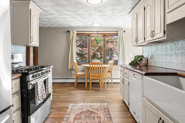 91 Bartholomew St, Peabody, MA 01960 - kitchen with stainless steel gas stove, dishwasher, tasteful backsplash, light wood-type flooring, and a baseboard radiator