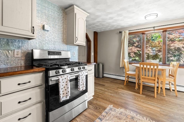 91 Bartholomew St, Peabody, MA 01960 - kitchen with gas stove, decorative backsplash, light wood-type flooring, a textured ceiling, and white cabinetry