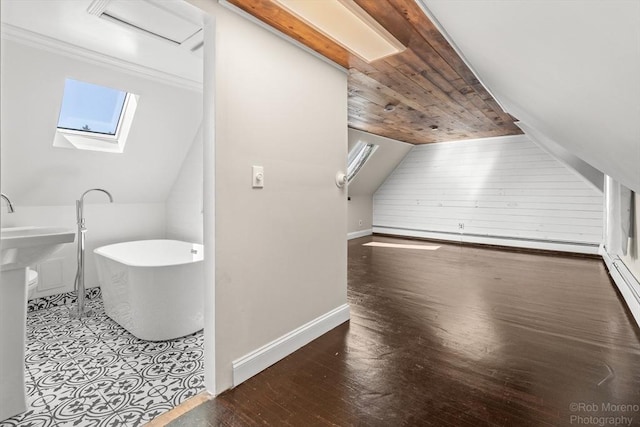 91 Bartholomew St, Peabody, MA 01960 - full bathroom with a freestanding tub, a skylight, vaulted ceiling, hardwood / wood-style flooring, and a baseboard heating unit
