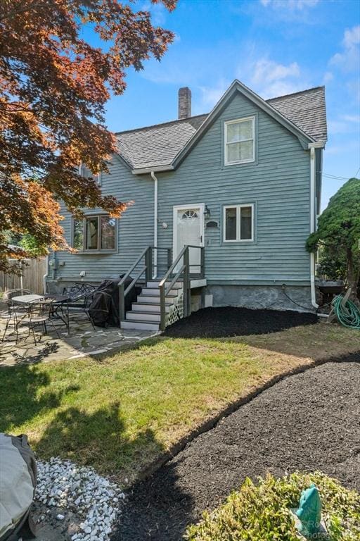 91 Bartholomew St, Peabody, MA 01960 - back of house featuring a patio, a chimney, and roof with shingles