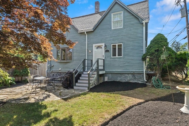91 Bartholomew St, Peabody, MA 01960 - rear view of house with a patio, a chimney, and a shingled roof