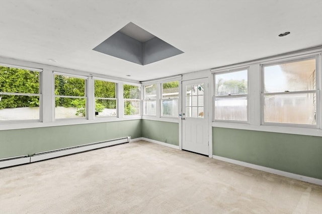 unfurnished sunroom with healthy amount of natural light, carpet flooring, a baseboard radiator, and baseboards