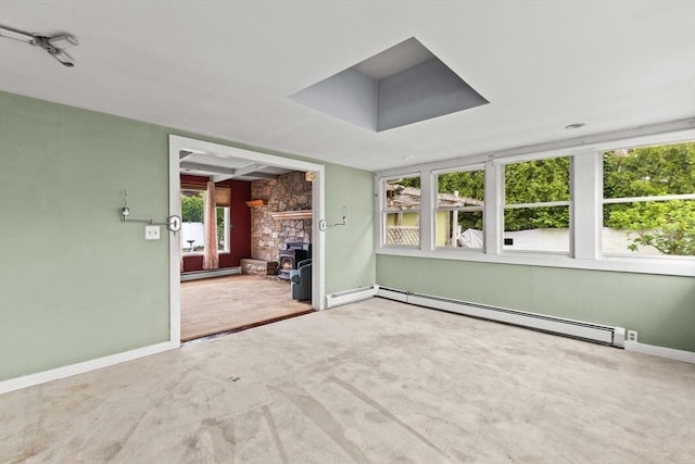 unfurnished sunroom featuring baseboard heating and healthy amount of natural light