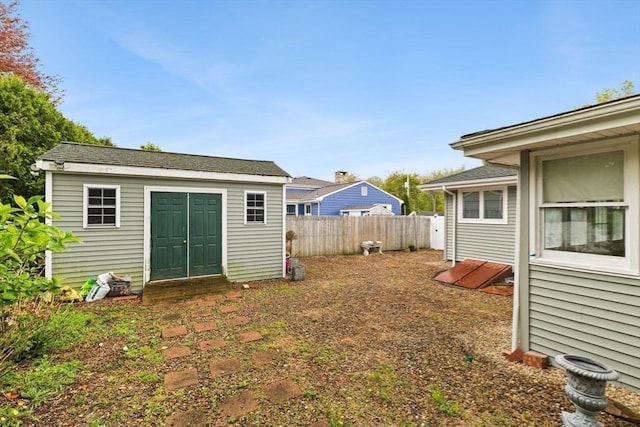 view of yard with fence and an outbuilding