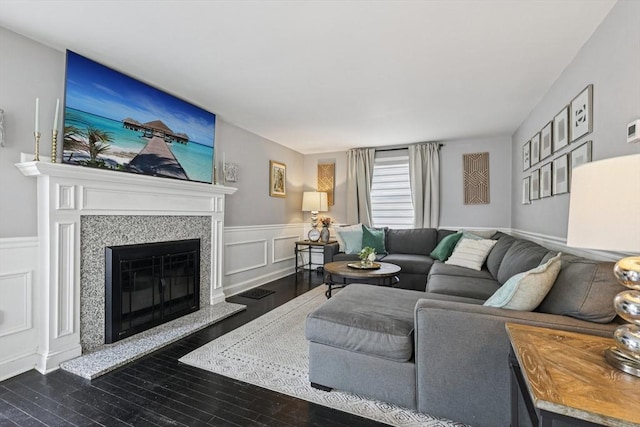 1792 Washington St, Braintree, MA 02184 - living room with dark wood-type flooring, a glass covered fireplace, wainscoting, and a decorative wall