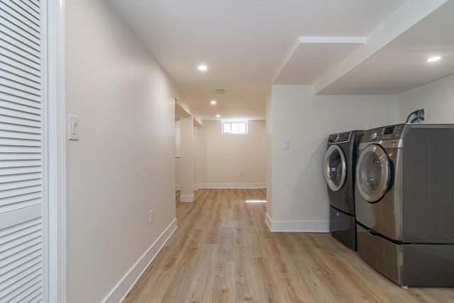 clothes washing area featuring baseboards, laundry area, light wood-style flooring, recessed lighting, and independent washer and dryer