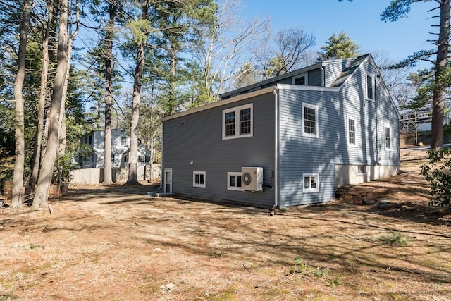 rear view of property featuring ac unit