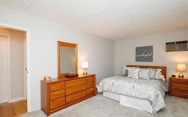 carpeted bedroom featuring a wall mounted air conditioner