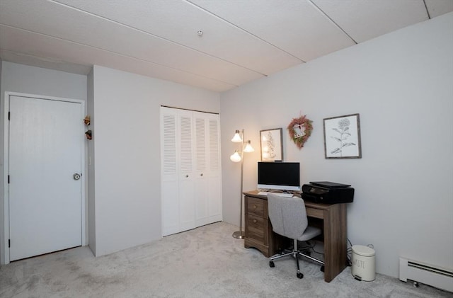 office space with baseboard heating and carpet