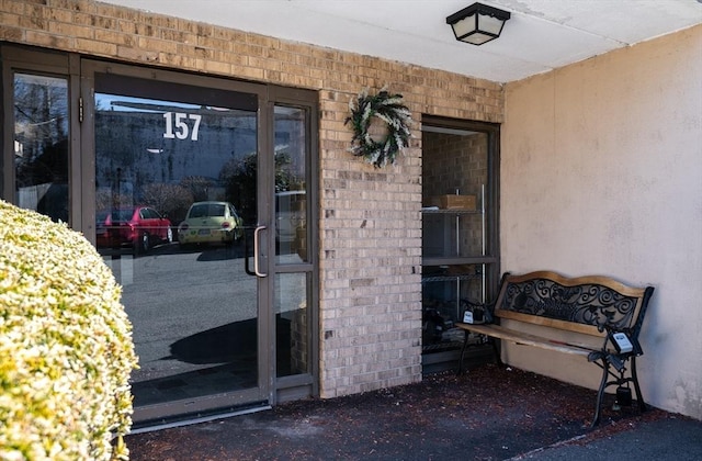 property entrance with brick siding