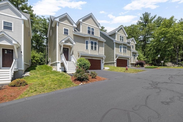 6 Comanche Ter Unit 6, Westford, MA 01886 - view of front of house featuring entry steps, an attached garage, and asphalt driveway