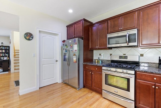 6 Comanche Ter Unit 6, Westford, MA 01886 - kitchen with stainless steel appliances, light wood finished floors, tasteful backsplash, recessed lighting, and dark stone countertops