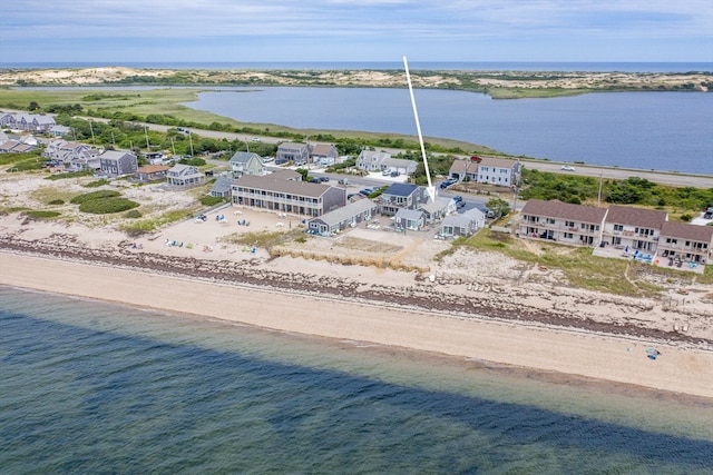 drone / aerial view with a beach view and a water view