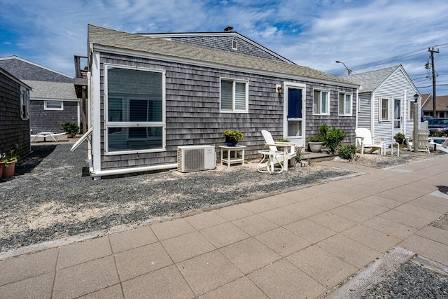 view of front of property with central AC and a patio area