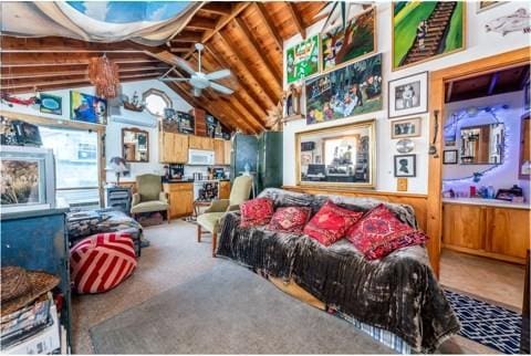 living room featuring ceiling fan and lofted ceiling