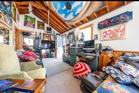 interior space with lofted ceiling, wooden walls, and carpet