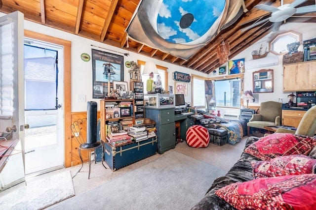 interior space featuring wooden walls, carpet, lofted ceiling with beams, and a wealth of natural light