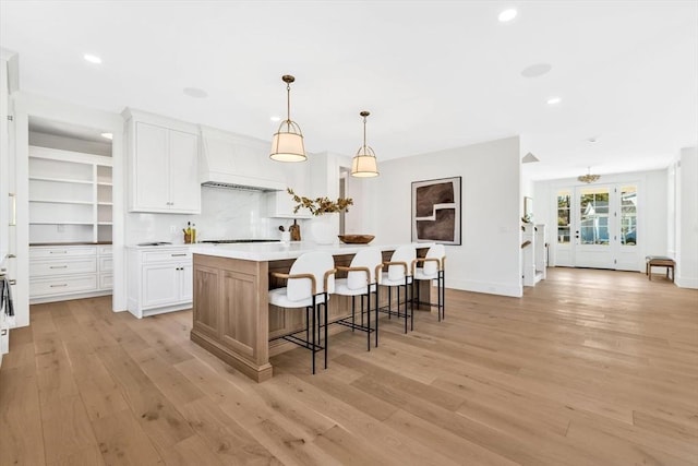 6 Willow Cir, Mashpee, MA 02649 - kitchen featuring custom range hood, light wood-type flooring, white cabinets, recessed lighting, and a spacious island