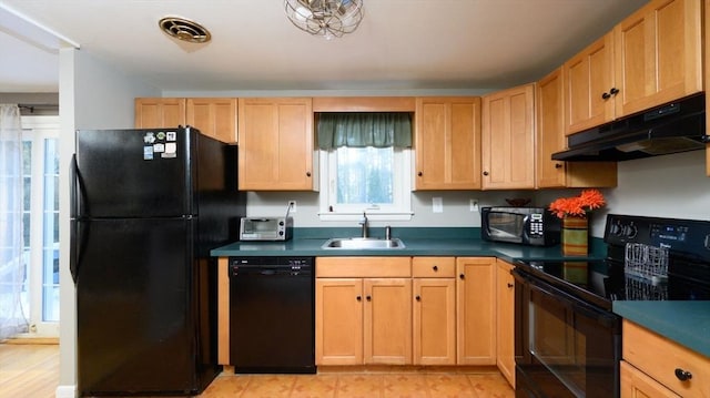 kitchen with light brown cabinetry, sink, and black appliances