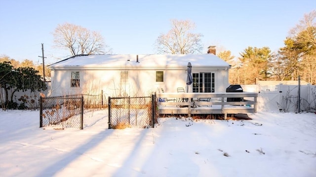 view of snow covered rear of property