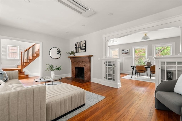 301 Pond St, Boston, MA 02130 - living area featuring hardwood / wood-style floors, a fireplace, stairway, and baseboards
