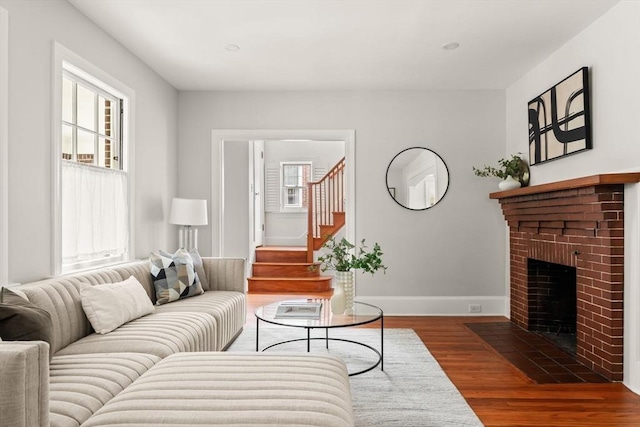 301 Pond St, Boston, MA 02130 - living room with wood finished floors, stairway, a brick fireplace, and baseboards