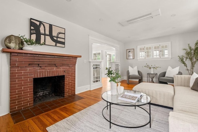 301 Pond St, Boston, MA 02130 - living area with wood finished floors, a fireplace, and plenty of natural light